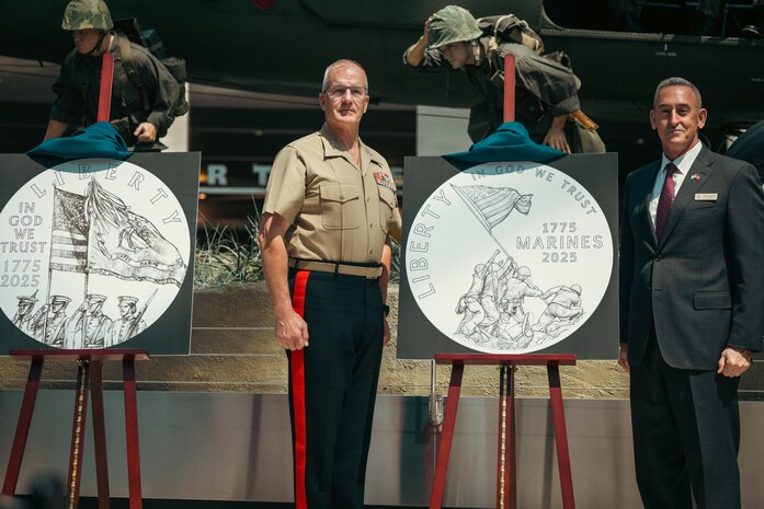 U.S. Marine Corps Lt. Gen. Gregg Olson, director of Marine Corps Staff, left, and retired U.S. Marine Corps Maj. Gen. James Lukeman, president and CEO of the Marine Corps Heritage Foundation, unveil the new trio of commemorative coins dedicated to the 250-year anniversary of the U.S. Marine Corps at the National Museum of the Marine Corps, Virginia, July 17, 2024. The coins are a testament to the courage, sacrifice and dedication of all Marines, ensuring that their stories will be remembered and celebrated. (U.S. Marine Corps photo by Lance Cpl. Joaquin Dela Torre)