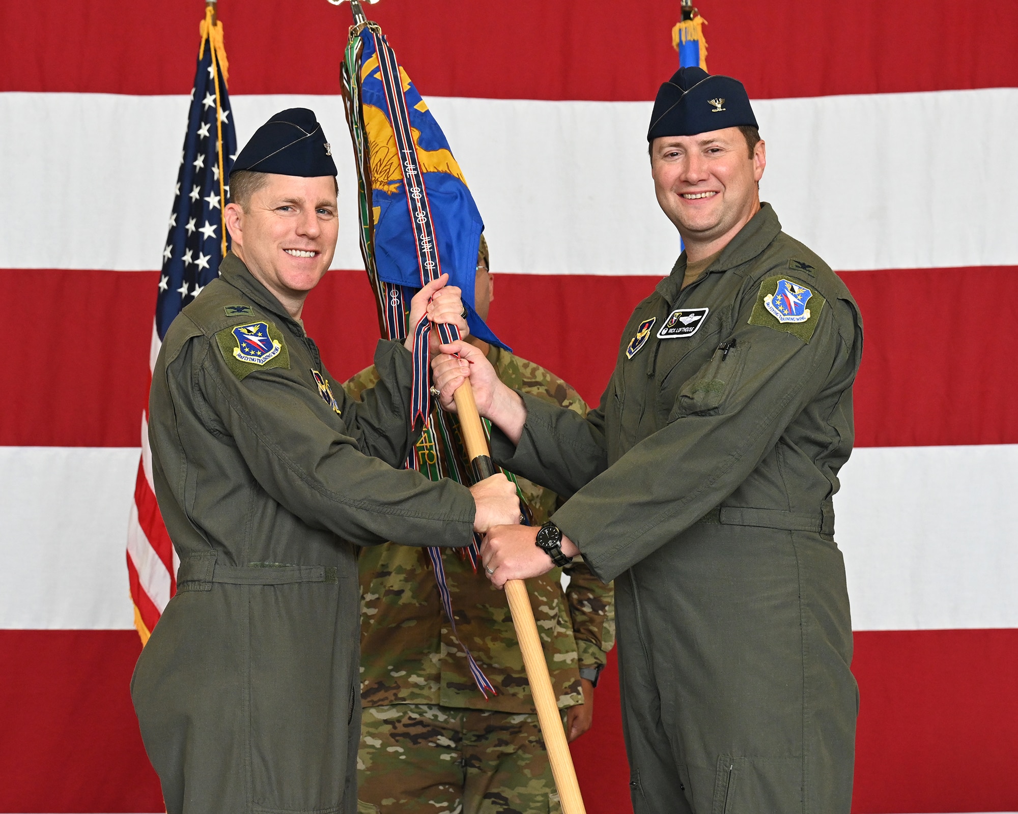 Col. Blech passes the guidon to Col. Lofthouse.