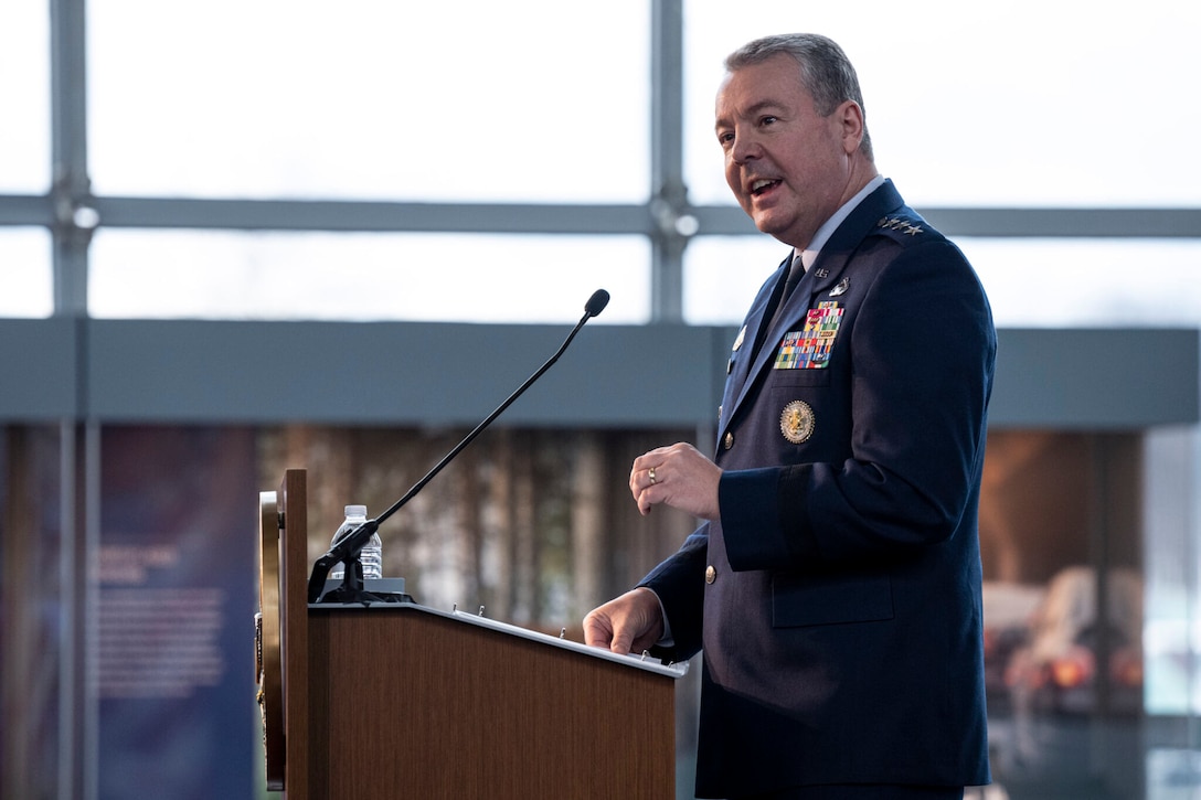An Air Force general stands at a lectern and speaks.