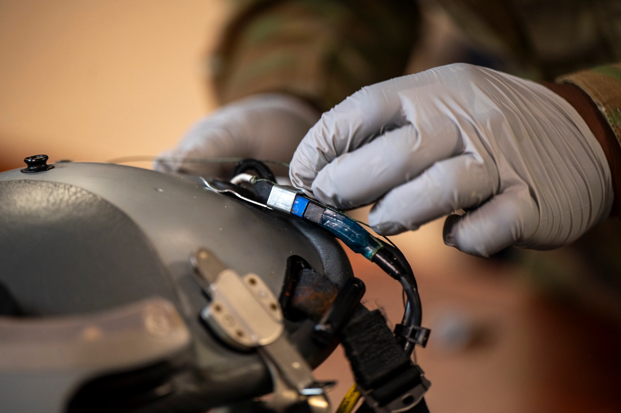 A military fixes a flight helmet