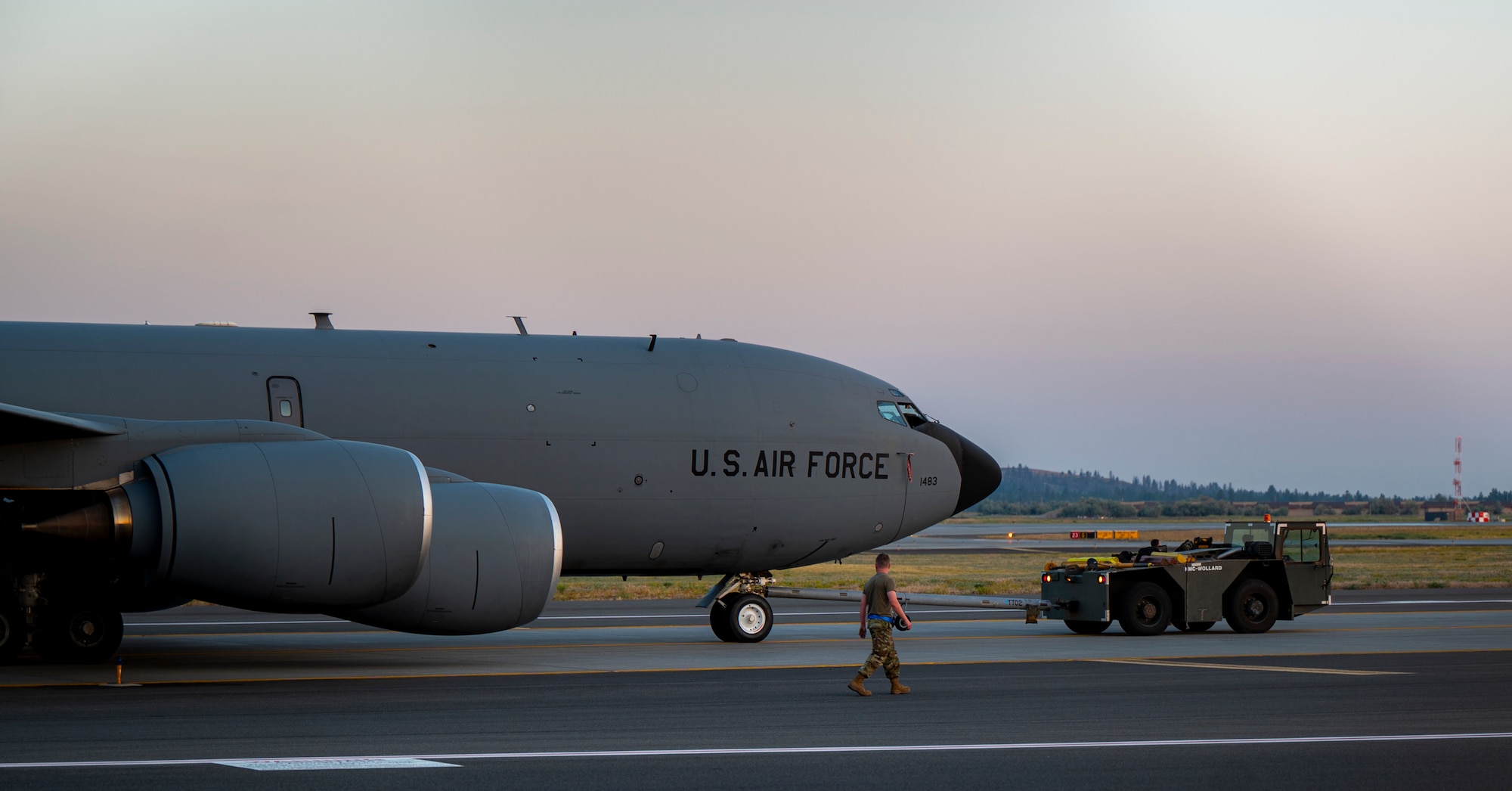 A KC-135 Stratotanker is towed on the flightline