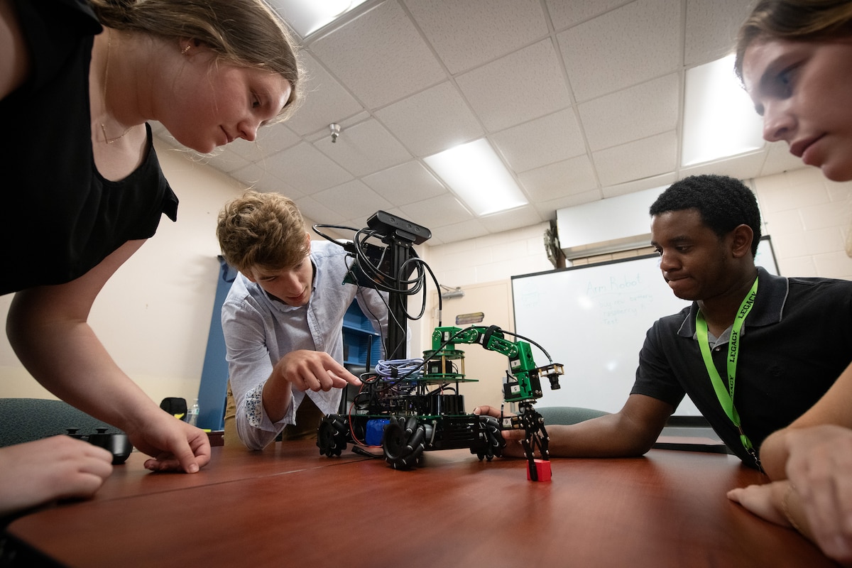 Owen Parry (middle left), 96th Range Control Squadron intern, calibrates a robot with his robotics team during a STEM Workstation at Eglin Air Force Base, Fla., June 25, 2024.