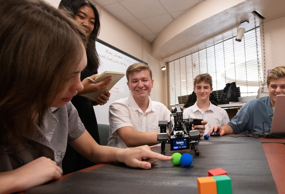 A group of STEM students with the Air Force Leadership Experience Growing Apprenticeships Committed to Youth (LEGACY) program work on a hands-on robotics activity in the STEM Workstation at Eglin Air Force Base, Fla., June 25, 2024.