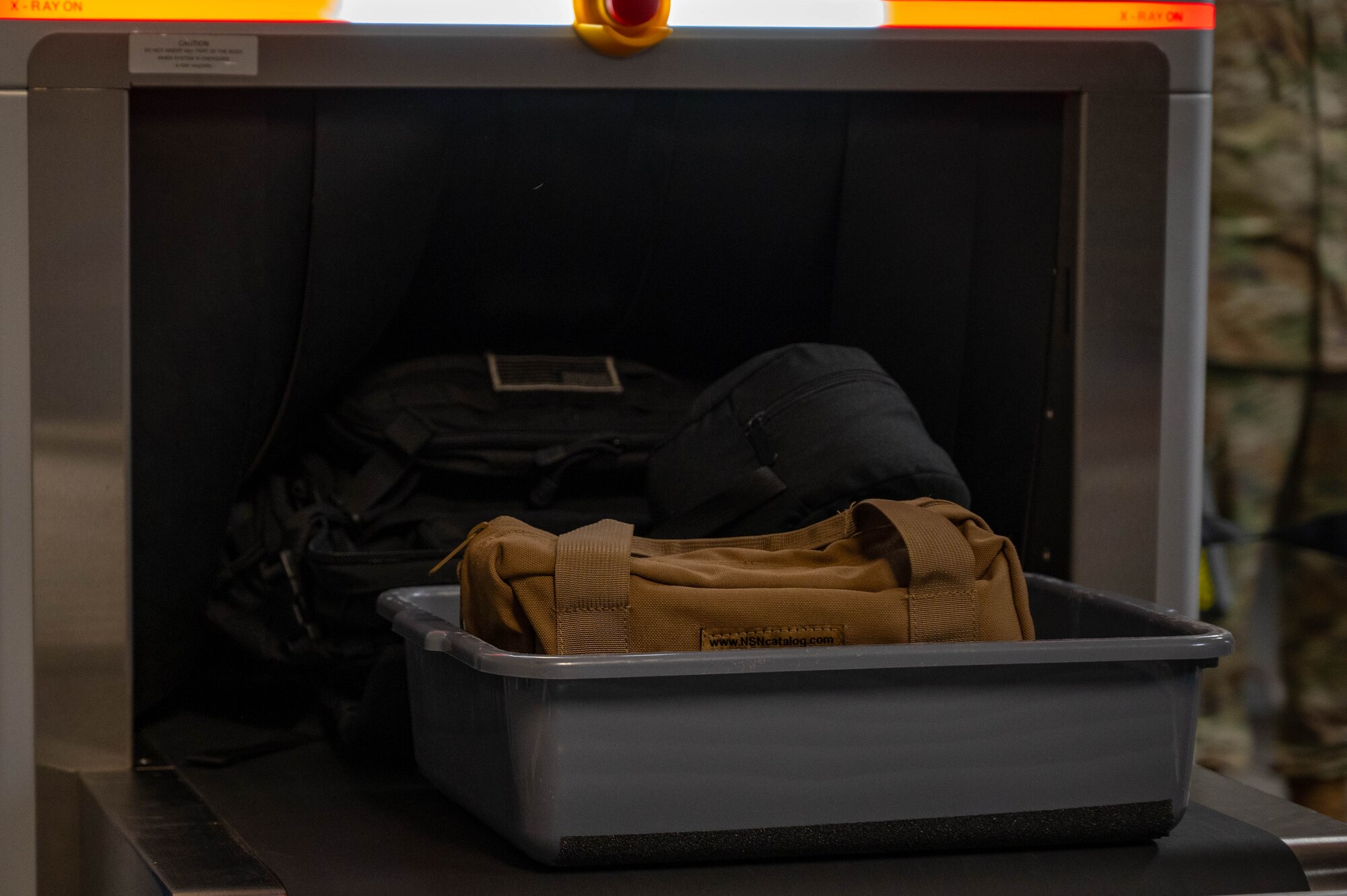 An X-ray security scanner scans luggage at the Minot Air Force Base (AFB) passenger terminal in preparation for exercise AGILE WARBIRD at Minot AFB, North Dakota, June 13, 2024. Exercises like these sharpen Airmen’s ability to mobilize quickly and ensure they are prepared to operate Minot bombers from anywhere at a moment’s notice. (U.S. Air Force photo by Senior Airman Alexander Nottingham)
