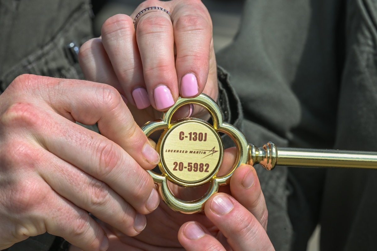 Maj. Gen. Melissa Coburn, 22nd Air Force commander, receives the ceremonial key for the new C-130J-30 Super Hercules at the Lockheed Martin production facility, Marietta, Georgia, July 16, 2024.