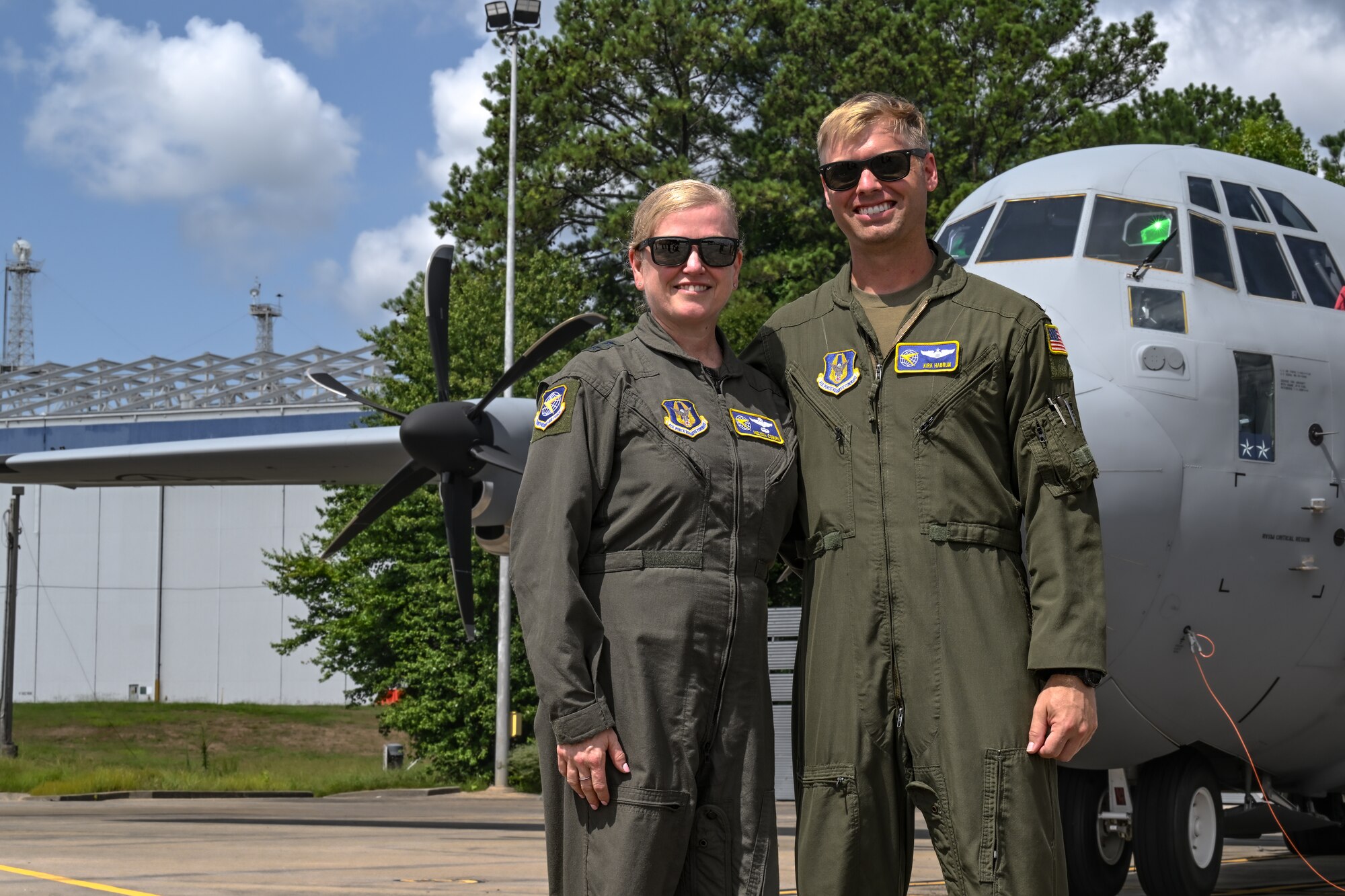 Maj. Gen. Melissa Coburn, 22nd Air Force commander, and Maj. Kirk Habrun, 22nd AF pilot flight examiner, pose for a photo in front of the C-130J-30 Super Hercules prior to takeoff at the Lockheed Martin production facility, Marietta, Georgia, July 16, 2024.