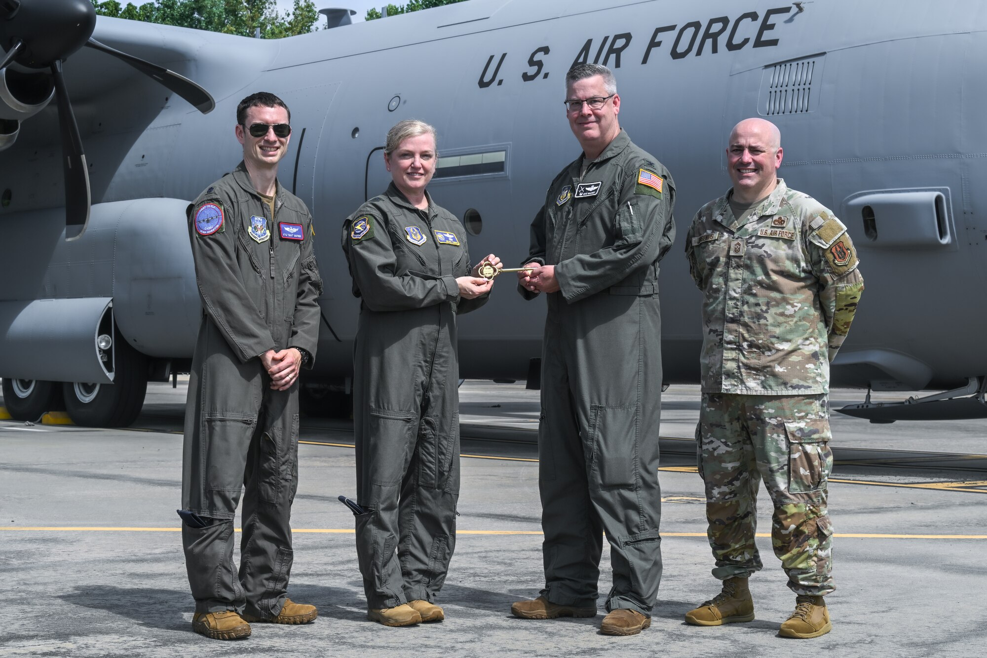 Col. Michael Maloney, 910th Airlift Wing commander, receives the ceremonial key for the new C-130J-30 Super Hercules from Maj. Gen. Melissa Coburn, 22nd Air Force commander, at the Lockheed Martin production facility, Marietta, Georgia, July 16, 2024.