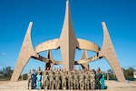 U.S. military members and Paraguyan medical students participating in AMISTAD 24 gather around the 75th anniversary monument of the founding of the Fernheim Colony in Filadelfia, Paraguay, July 16, 2024. AMISTAD brings U.S. military health professionals together with partner nation medical teams to train and learn best practices together. This 12th Air Force (Air Forces Southern) led mission delivers valuable experiences to U.S. and partner nation medical professionals while increasing their ability to quickly work together in emergency situations. (U.S. Air Force photo by Tech. Sgt. Carly Feliciano)