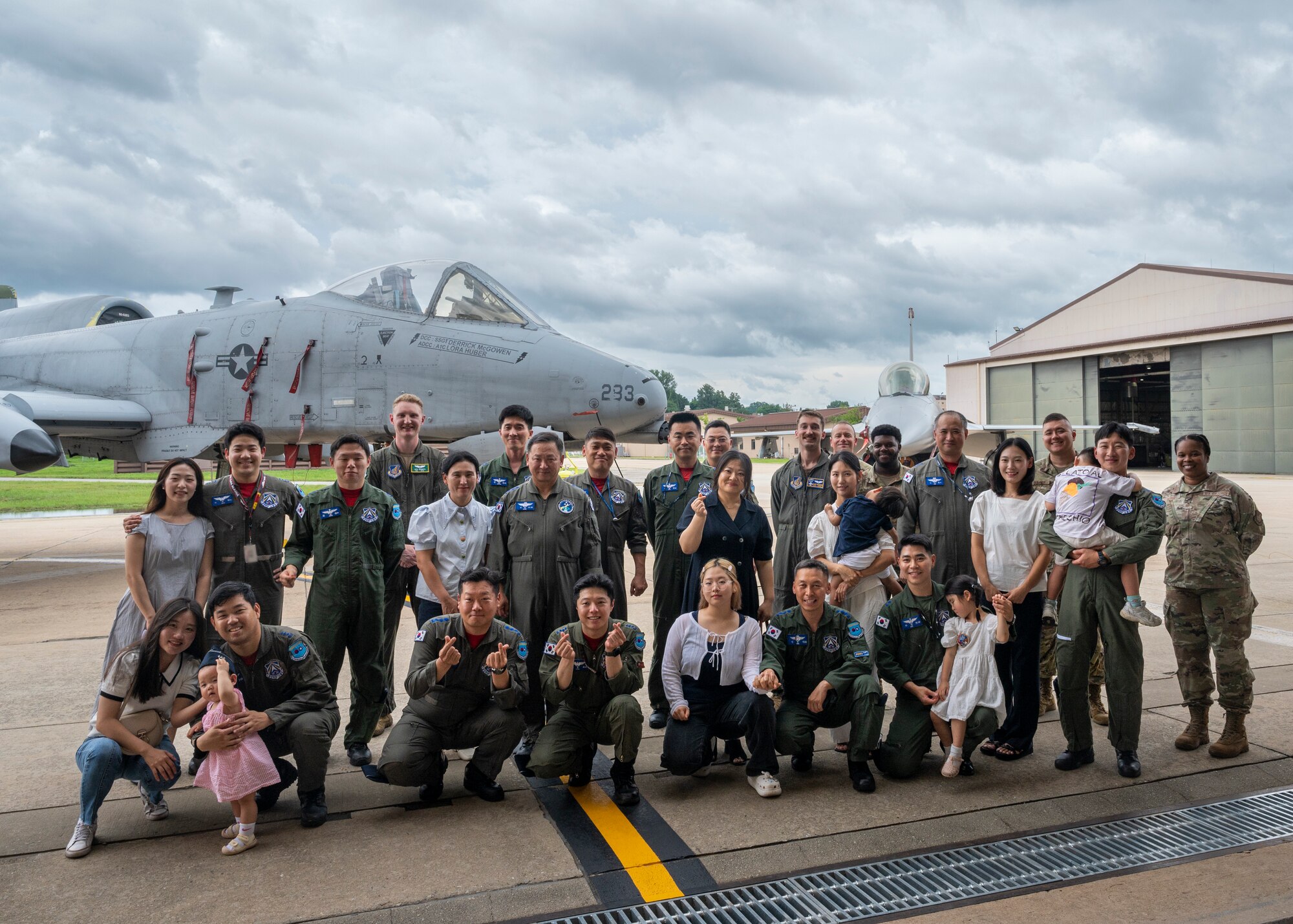 U.S. Air Force Airmen assigned to the 51st Fighter Wing and Republic of Korea Air Force service members and families pose for a photo during Pilot’s Day at Osan Air Base, Republic of Korea, July 17, 2024. Over 21 family members attended the event to learn more about the capabilities of various aircraft on base and the important role pilots play in enabling security and stability within the Korean peninsula. (U.S. Air Force photo by Senior Airman Sabrina Fuller-Judd)