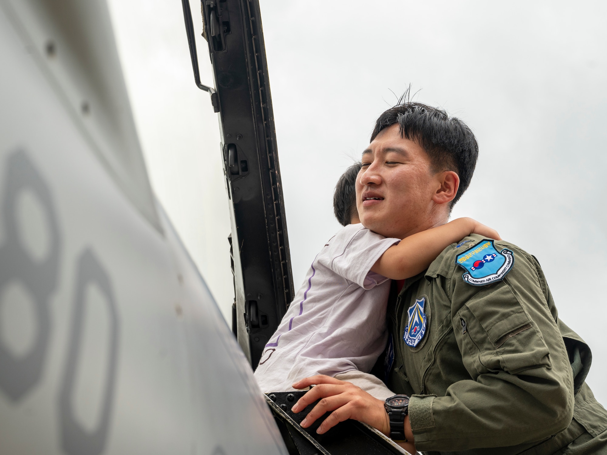 Maj. Song, Moon-seong, Republic of Korea Air Force Operations Command electric warfare/information operations planning, embraces his child during Pilot’s Day at Osan Air Base, Republic of Korea, July 17, 2024. Established in 2008, Pilot’s Day commemorates the date of the first flight by the ROKAF during the Korean War on July 3, 1950. Today, the event recognizes the perseverance and sacrifice of active and veteran pilots who brought and continue to bring security and stability to the skies of the Korean peninsula. (U.S. Air Force photo by Senior Airman Sabrina Fuller-Judd)