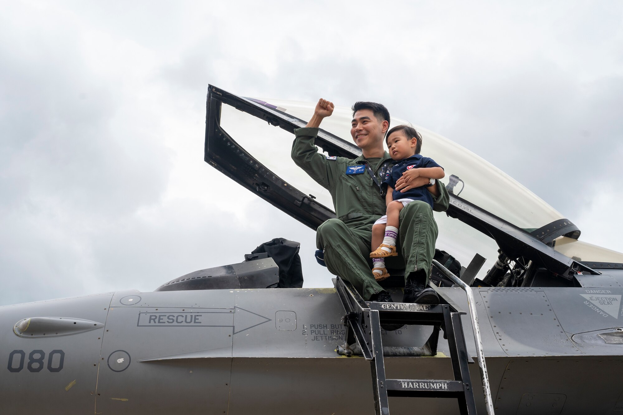 Maj. Ha, Seung-wan, Republic of Korea Air Force Operations Command, concept developer, poses for a photo with his child during Pilot’s Day at Osan Air Base, Republic of Korea, July 17, 2024. The special event showcased the job responsibilities and missions of the U.S. Airmen and ROKAF service members and their families. (U.S. Air Force photo by Senior Airman Sabrina Fuller-Judd)