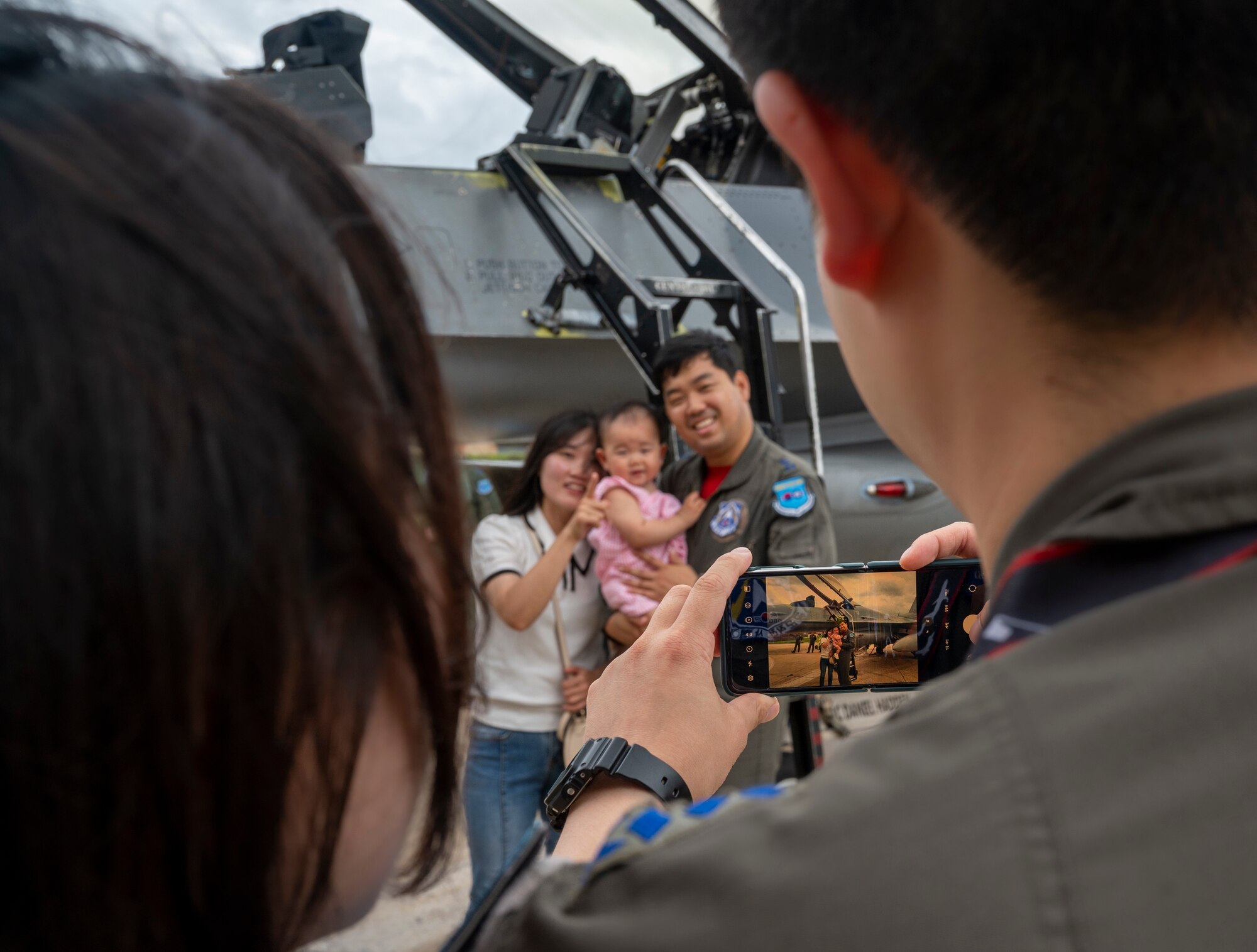 Republic of Korea Air Force service members and their families take a photo by an F-16 Fighting Falcon during Pilot’s Day at Osan Air Base, Republic of Korea, July 17, 2024. Over 21 family members attended the event to learn more about the capabilities of various aircraft on base and the important role pilots play in enabling security and stability within the Korean peninsula. (U.S. Air Force photo by Senior Airman Sabrina Fuller-Judd)