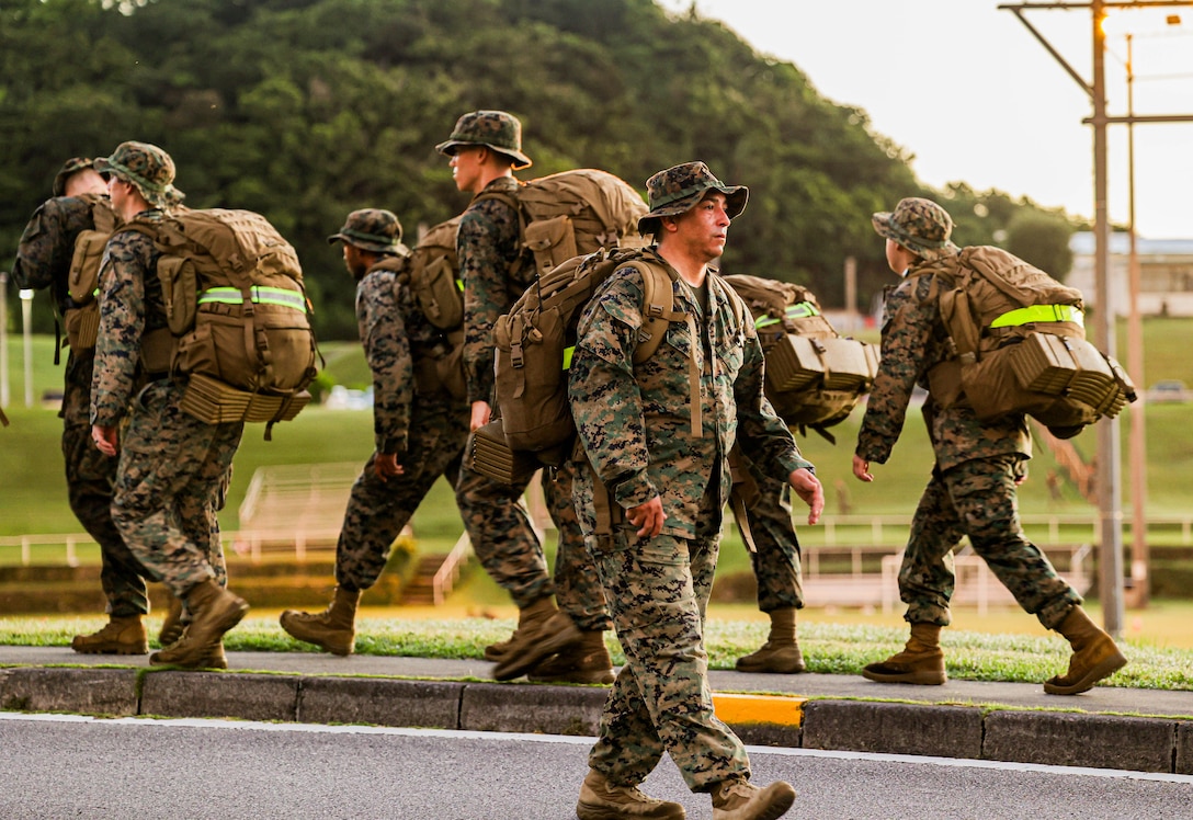 MGySgt Benitez, the 3rd MEB operations chief, supervises Sailors and Marines as they hike aboard Camp Courtney, Okinawa, Japan, July 19, 2024.