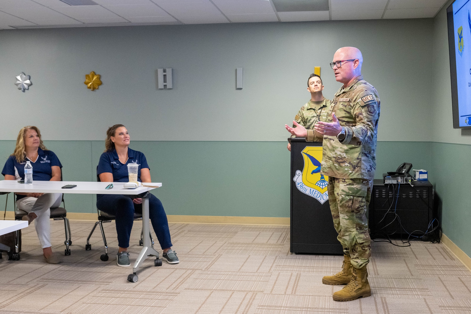 U.S. Air Force Col. Jamison Elder, 436th Medical Group commander, welcomes a group of honorary commanders for a tour of the medical clinic at Dover Air Force Base, Delaware, July 18, 2024. The HCCs toured various elements of the 436th MDG to familiarize them with the group's facilities, mission and capabilities. (U.S. Air Force photo by Mauricio Campino)