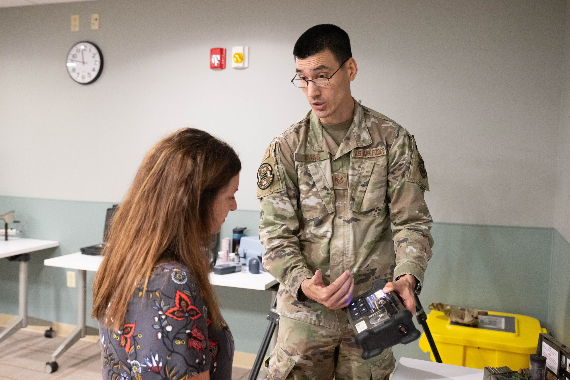 U.S. Air Force Staff Sgt. Steven Staab, 436th Operational Medical Readiness Squadron noncommissioned officer in charge of radiation safety and health, shows a handheld hazardous material identifier to a group of honorary commanders during a tour of the medical clinic at Dover Air Force Base, Delaware, July 18, 2024. The HCCs toured various elements of the 436th MDG to familiarize them with the group's facilities, mission and capabilities. (U.S. Air Force photo by Mauricio Campino)