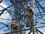 Pennsylvania Air National Guard Staff Sgt. Jeremiah Leonard, left, and Tech. Sgt. Shane Miller, with the 258th Air Traffic Control Squadron in Johnstown, Pennsylvania, work on a pick-off rescue while on a radar tower during a two-week training exercise that ended June 16, 2024. The 258th Air Traffic Control Squadron is a geologically separated unit of the 171st Air Refueling Wing.