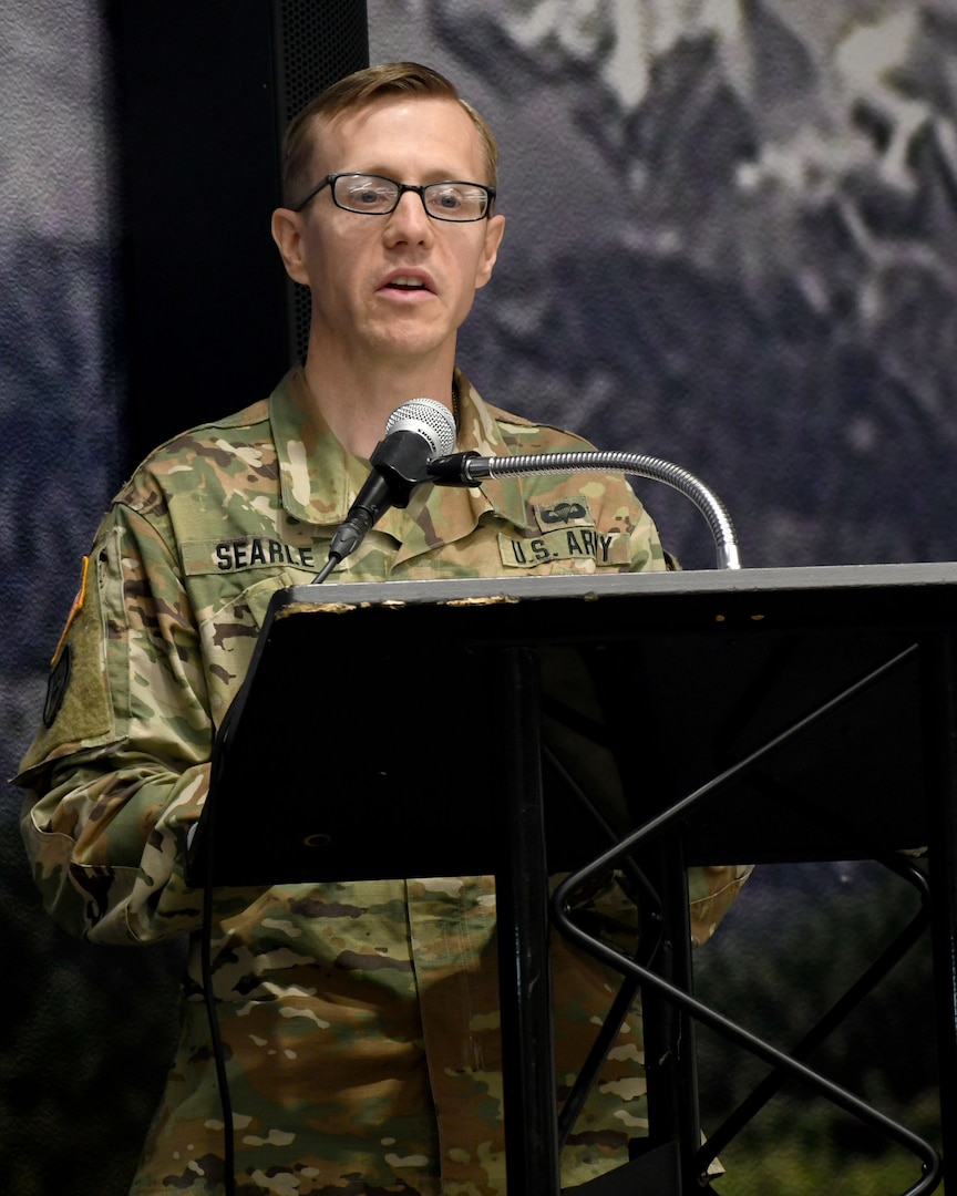 Photo of Lt. Col. Russell K. Searle, outgoing commander of the Fort Drum Dental Health Activity, giving a speech during a change of command ceremony.