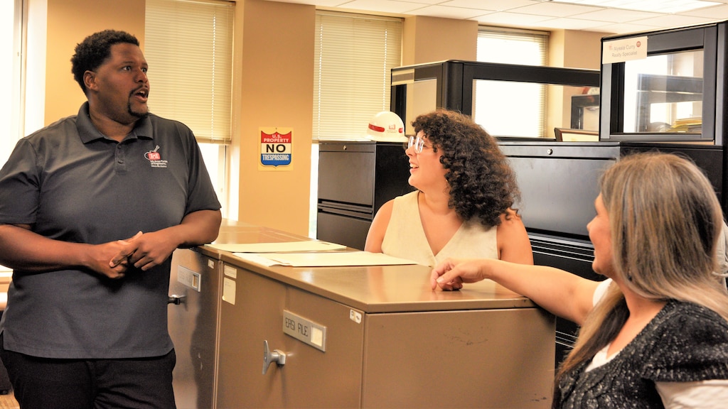 Mike Berry, U.S. Army Corps of Engineers Nashville District realty specialist, speaks with realty specialists Marianne Rivera and Angela Jones, July 17, 2024. The Nashville District recently announced Berry as the February employee of the month. (USACE Photo by Braden Simmons)