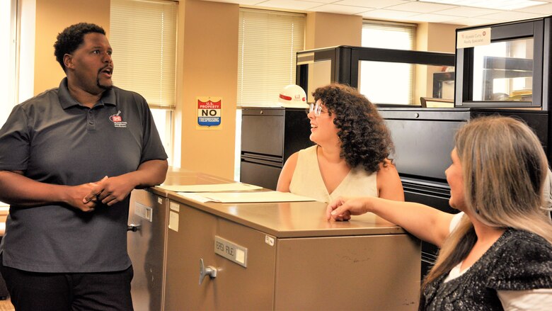 Mike Berry, U.S. Army Corps of Engineers Nashville District realty specialist, speaks with realty specialists Marianne Rivera and Angela Jones, July 17, 2024. The Nashville District recently announced Berry as the February employee of the month. (USACE Photo by Braden Simmons)