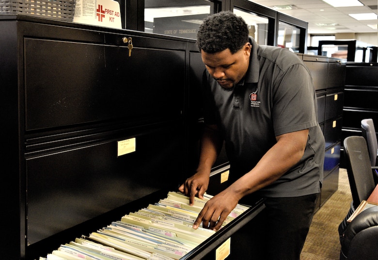 Mike Berry, U.S. Army Corps of Engineers Nashville District realty specialist, examines a cabinet of documents in the Real Estate office in Nashville Tennessee, July 17, 2024. The Nashville District recently announced Berry as the February employee of the month. (USACE Photo by Braden Simmons)