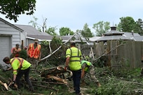 New York Air National Guard Airmen assigned to the 174th Attack Wing clear debris in Rome, New York, July 17, 2024, alongside city employees. The New York National Guard deployed 25 Airmen from the 174th Attack Wing, 25 Soldiers from the 2nd Battalion, 108th Infantry, and an additional 10 Soldiers to help clear debris left by a July 16 storm.