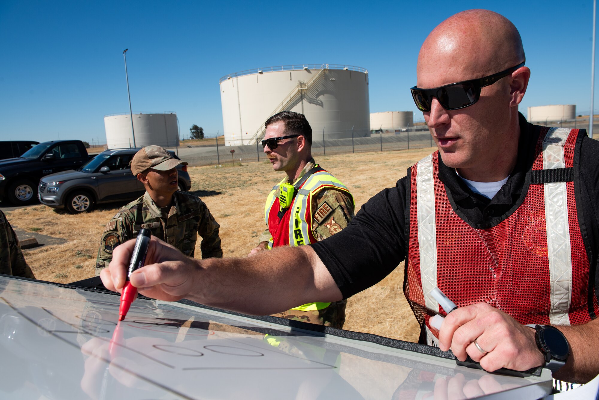 Fire chief drawing the incident plan on a whiteboard.
