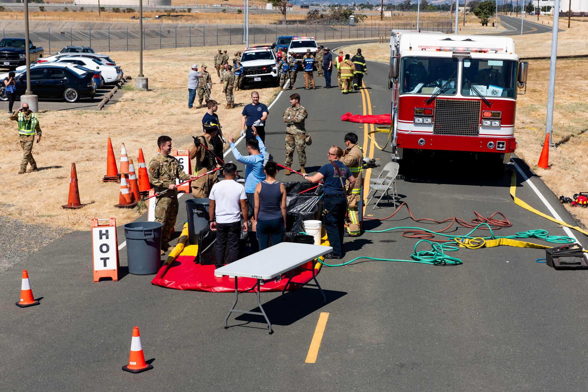An overall view of first responders decontaminating simulated patients.