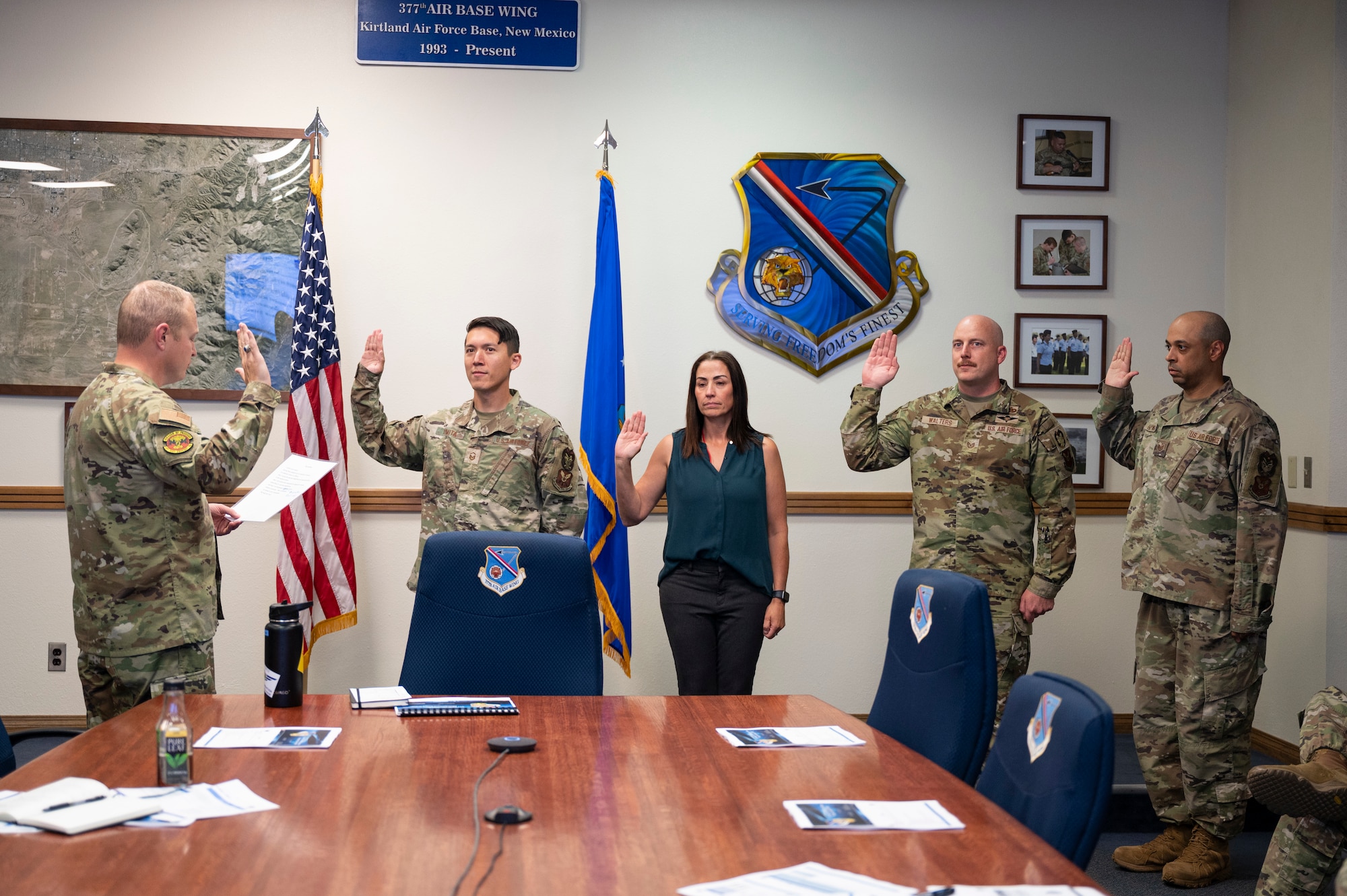 A group holds their right hand up to say an oath.