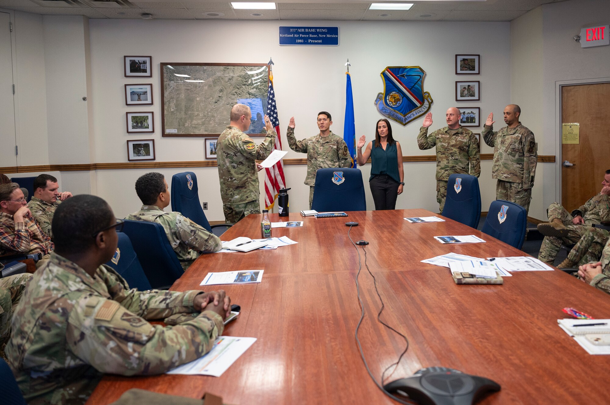 A group holds their right hand up to say an oath.