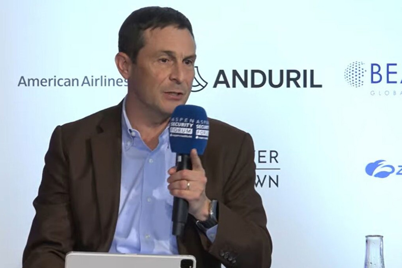 A person speaks with a microphone.