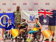 Team Army gold medalist Spc. (R) Corine Hamilton is flanked by Air Force Silver Medalist Heather Sealover and Team Australia bronze medalist Diane Jackson in the women’s seated shotput medal ceremony at the 2024 Department of Defense Warrior Games