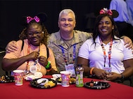 U.S. Army veteran Corine Hamilton poses with her mother, Nadine Hamilton, and U.S. Army Command Sgt. Maj. Joel Zecca at the character breakfast during the 2024 Department of Defense Warrior Games