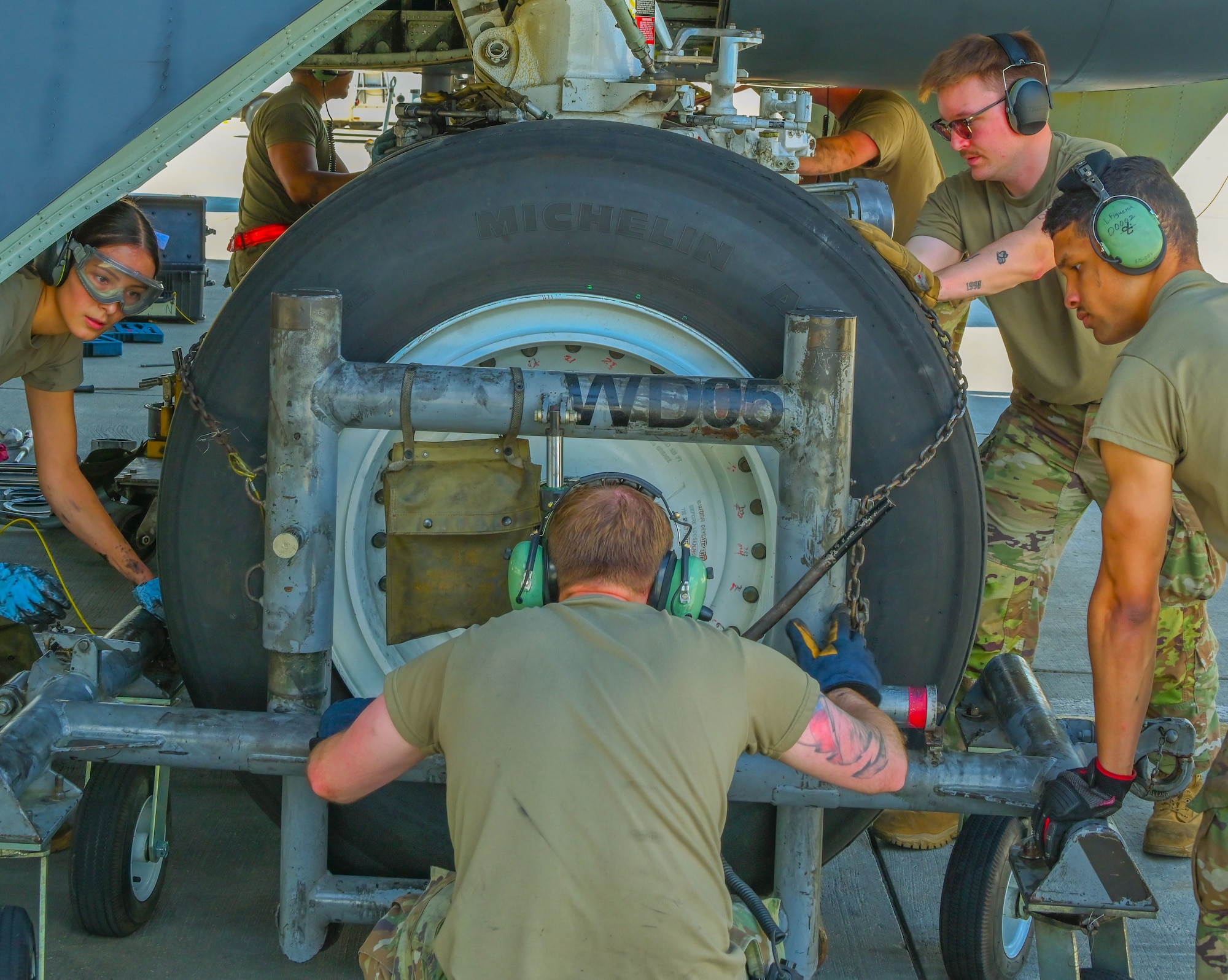 Airmen assigned to the 5th Aircraft Maintenance Squadron compete in the 5th Maintenance Group’s inaugural Mission Generation Competition at Minot Air Force, North Dakota, July 17, 2024. The competition consisted of changing a jet tire, assembling guided munitions, and attaching munitions to a B-52H Stratofortress.