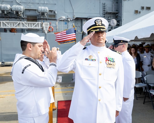 Cmdr. Clinton Christofk, commanding officer of the Virginia-class fast-attack submarine USS Washington (SSN 787), renders a salute to sideboys during the boat’s change of command ceremony at Naval Station Norfolk, July 19, 2024.