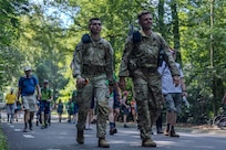 U.S. Army Sgt. 1st Class Corrie Heffner and Pfc. Damien Boccardi, both assigned to V Corps, walk up the largest hill on the course on the route of the Nijmegen March on July 18, 2024, in Nijmegen, Netherlands. Heffner and Boccardi learned about the importance of and connection to Operation Market Garden during their experience at the Nijmegen March. Heffner and Boccardi completed day three, known as the day of hills, and remained in contention to finish the march. (U.S. Army photo by Capt. Michael Mastrangelo)