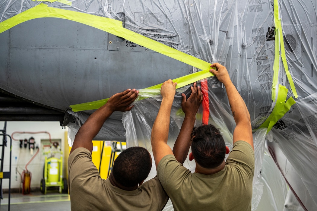 U.S. Staff Sgt. William Rogers, 23rd Maintenance Squadron aircraft structural maintenance craftsman, left, and U.S. Air Force Senior Airman Joshua Strickland, 23rd Maintenance Squadron aircraft structural maintenance journeyman, right, prepare an A-10C Thunderbolt II for re-painting at Moody Air Force Base, Georgia, July 16, 2024. After receiving a new paint job at a maintenance depot, the A-10C Thunderbolt II returns to Moody AFB where Airmen from the 23rd Maintenance Squadron add the world-famous Flying Tiger shark teeth to its nose. i (U.S. Air Force photo by Airman 1st Class Leonid Soubbotine)