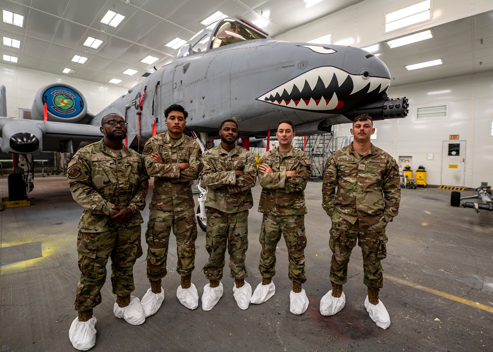 U.S. Air Force Airmen assigned to the 23rd Maintenance Squadron corrosion control pose in front of a freshly painted A-10C Thunderbolt II at Moody Air Force Base, Georgia, July 19, 2024.These skilled Airmen were involved in ensuring that the paint was successfully applied to the nose art along with the jet not corroding due to the strong chemicals present in the paint. (U.S. Air Force photo by Airman 1st Class Leonid Soubbotine)