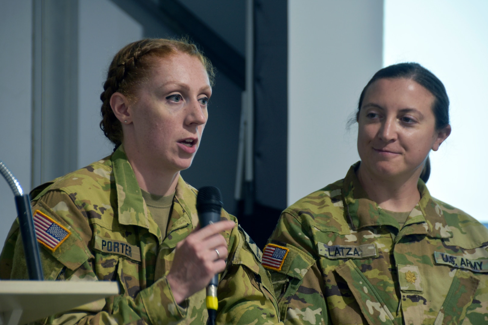 Capt. Meredith Porter, the commander of the Wisconsin Army National Guard’s Company C, 1st Battalion, 168th Aviation Regiment in West Bend, Wis.,  discusses her career in military aviation as Maj. Sarah Lastza, commander of Company A, 1st Battalion, 147th Aviation Regiment in Madison, Wis., looks on during a panel discussion July 26 as part of the Experimental Aircraft Association’s WomenVenture, an effort to honor and promote women’s role in flight during the EAA’s annual AirVenture in Oshkosh, Wis. Wisconsin Department of Military Affairs photo by Vaughn R. Larson