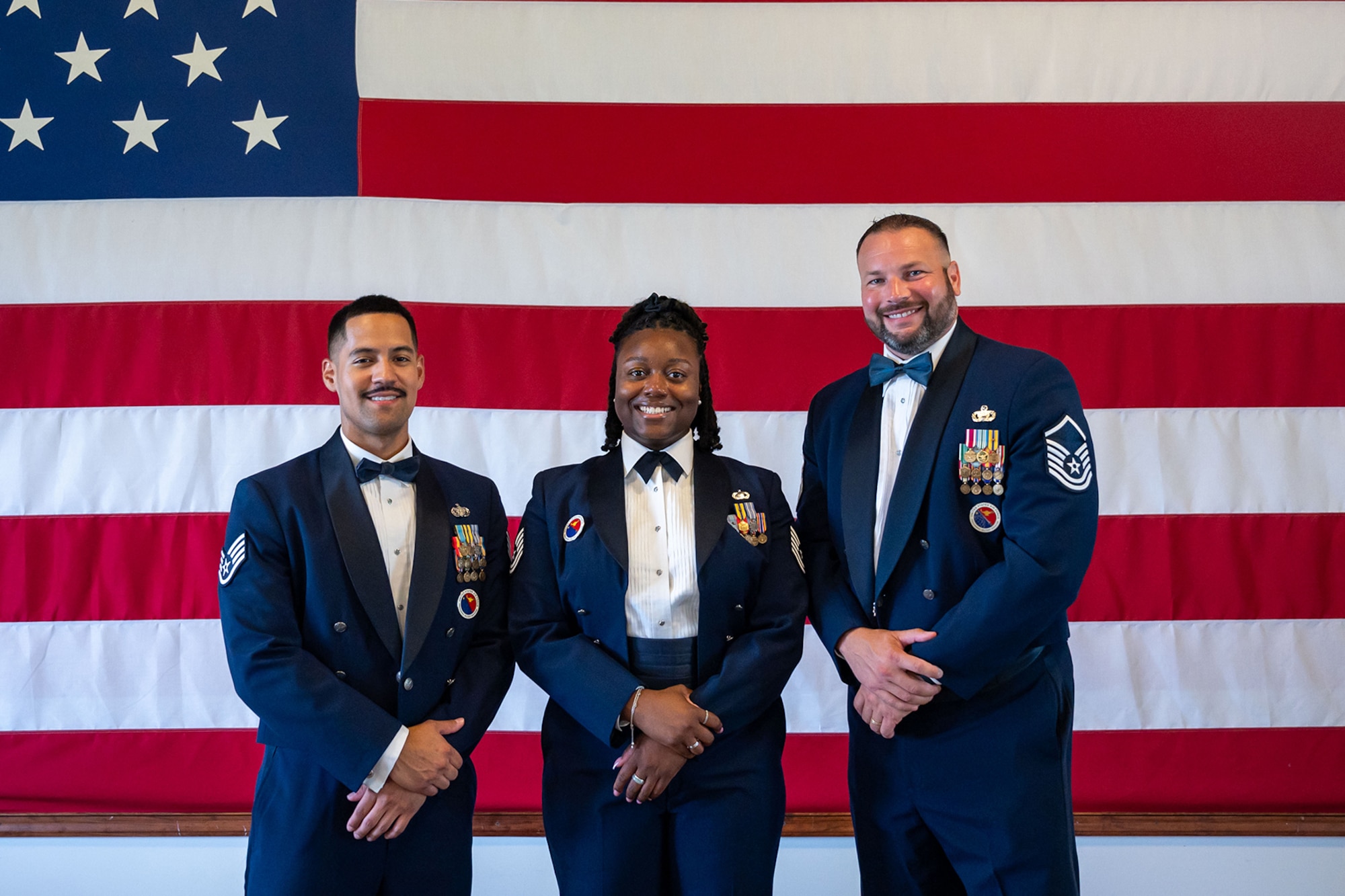 From the left, U.S. Air Force Staff Sgt. John De La Cruz, Tech. Sgt. Keishauna Howard, both Airman Leadership School instructors, along with Master Sgt. Joshua Hoffman, 436th Force Support Squadron ALS commandant, pose for a photo at Dover Air Force Base, Delaware, July 18, 2024. The ALS cadre was named the best in Air Mobility Command for 2023. Not pictured is Staff Sgt. Osmany Linares. (U.S. Air Force photo by Senior Airman Amanda Jett)