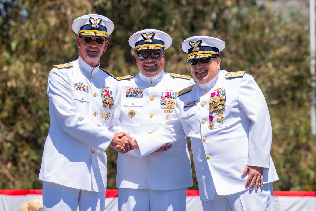 From left, Rear Adm. Andrew Sugimoto, Vice Adm. Andrew Tiongson and Rear Adm. Joseph Buzzella render a salute during the playing of the national anthem during a change-of-command ceremony on Coast Guard Island in Alameda