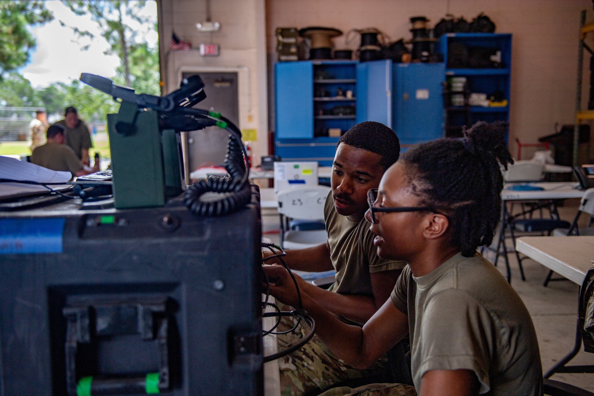 U.S. Air Force Airman 1st Class Samera Epperson, 23rd Communications Squadron tactical radio technician, sets up comm equipment during a Rehearsal of Concept (ROC) drill at Moody Air Force Base, Georgia, July 18, 2024.