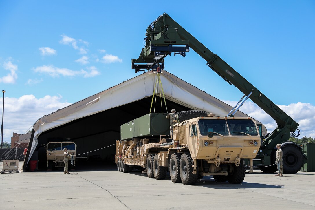 Soldiers assigned to Bravo Battery, 5th Battalion, 3rd Field Artillery (Long Range Fires Battalion), 1st Multi-Domain Task Force, swap a pod on one of the Long Range Hypersonic Weapon Transporter Erector Launchers in preparation for exercise Resolute Hunter 24-2 on Joint Base Lewis-McChord, Wash., June 24, 2024.