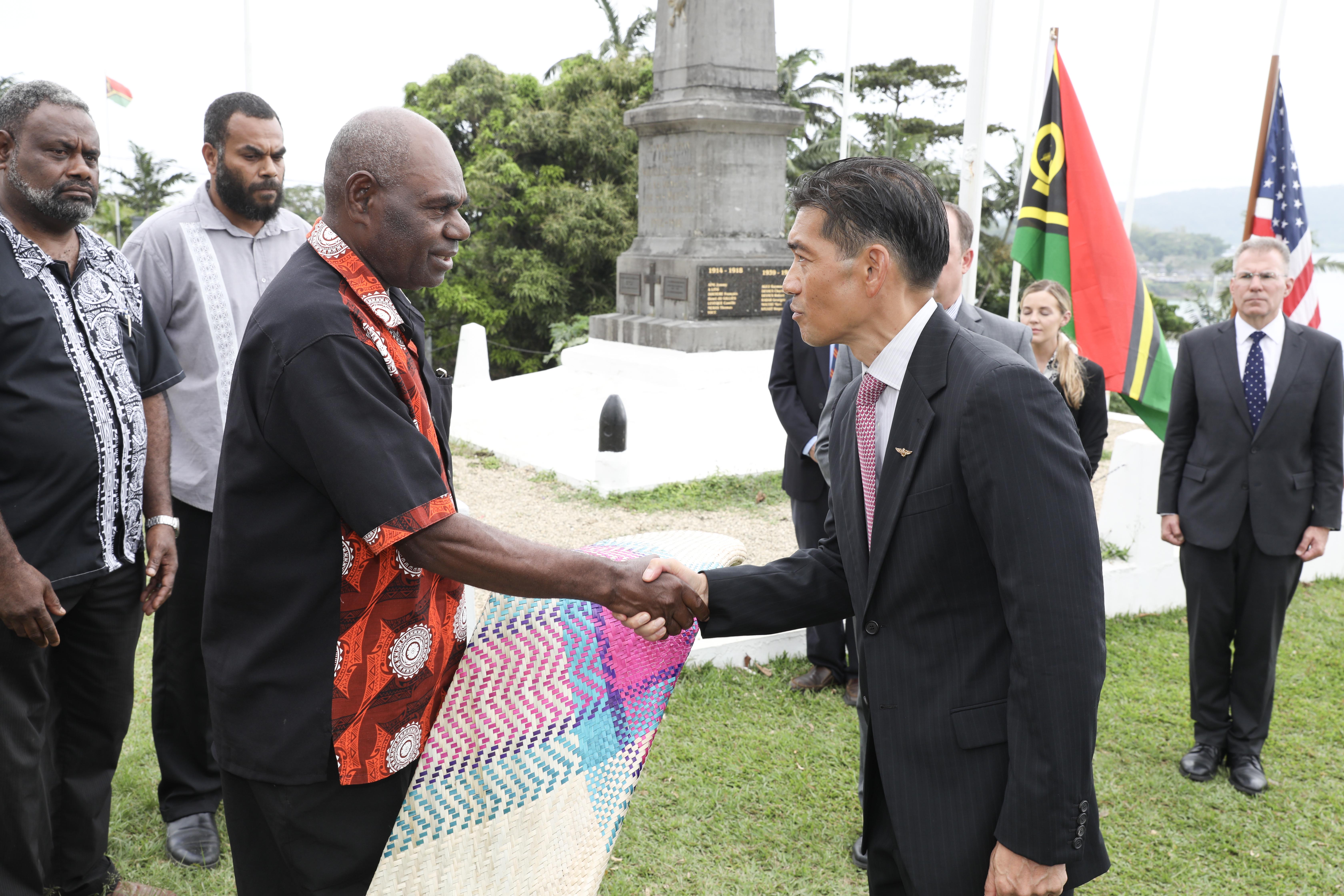 PORT VILA, Vanuatu (July 17, 2024) U.S. Navy Capt. Mark Asuncion, right, the Senior U.S. Official in Vanuatu, shakes hands with Chief August, Chairman of the Vanuatu National Cultural Council, after presenting a ceremonial mat during a ceremonial exchange of possible human remains attended by representatives from the Australian High Commission in Vanuatu, The Vanuatu Mobile Force, the Defense POW/MIA Accounting Agency, USAID, and servicemembers assigned to Pacific Partnership 24-2 at the Efate Port Vila War Memorial in Port Vila, Vanuatu. July 17, 2024. The possible human remains evidence were recovered from a U.S. Navy PBY-5 Catalina that crashed in what is now the Republic of Vanuatu during World War II. The DPAA mission is to search for, find and account for missing Defense Department personnel from World War II, the Korean War, the Vietnam War, the Cold War, the Gulf War and other recent conflicts. More than 82,000 Americans remain missing from those conflicts, with 34,000 believed to be recoverable, according to DPAA. (U.S. Navy Photo by Mass Communication Specialist 1st Class Ryan D. McLearnon.)
