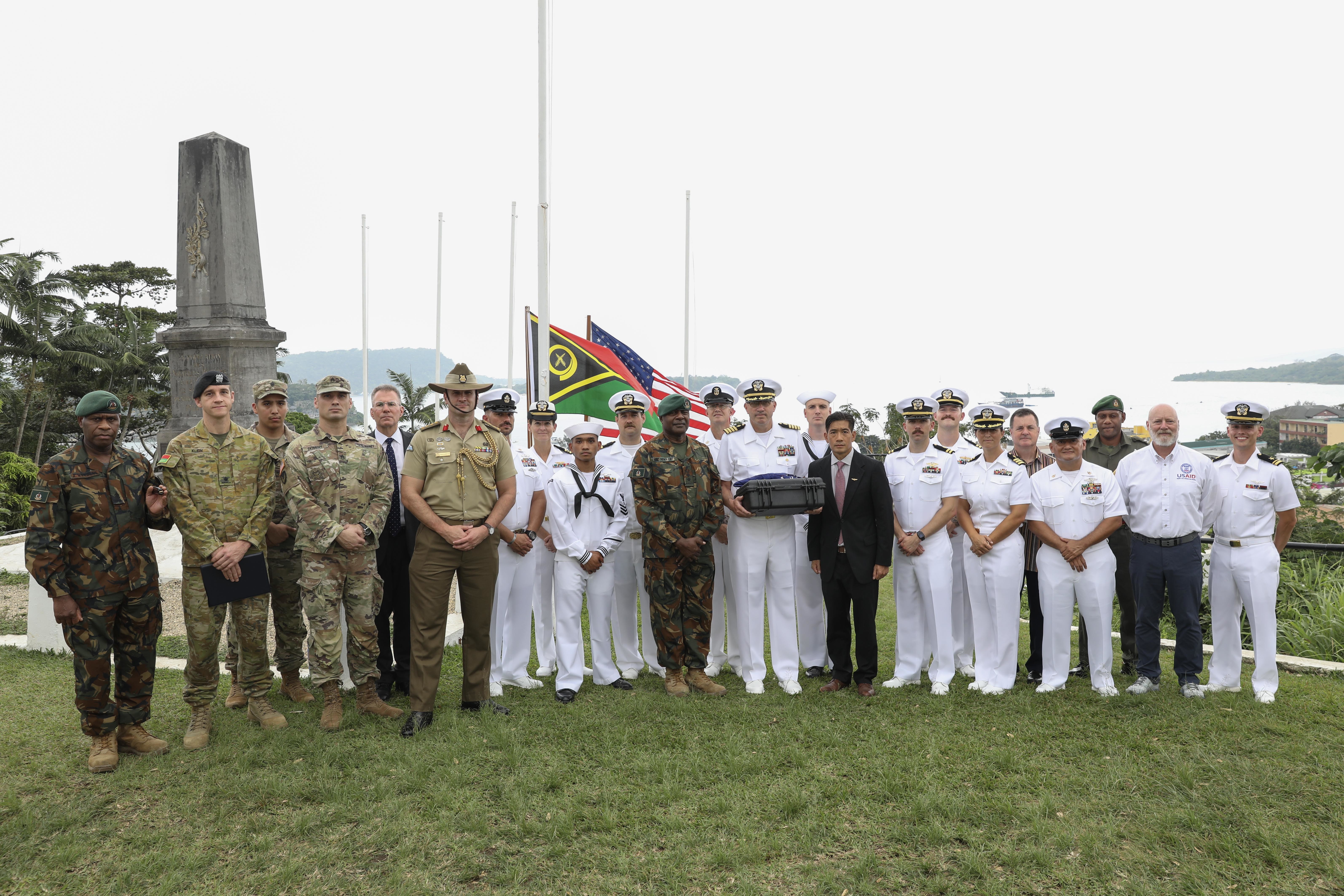 PORT VILA, Vanuatu (July 17, 2024) Servicemembers from the US, Australia and Vanuatu pose for a photo following a ceremonial exchange of possible human remains at the Efate Port Vila War Memorial in Port Vila, Vanuatu. July 17, 2024. The possible human remains evidence were recovered from a U.S. Navy PBY-5 Catalina that crashed in what is now the Republic of Vanuatu during World War II. The DPAA mission is to search for, find and account for missing Defense Department personnel from World War II, the Korean War, the Vietnam War, the Cold War, the Gulf War and other recent conflicts. More than 82,000 Americans remain missing from those conflicts, with 34,000 believed to be recoverable, according to DPAA. (U.S. Navy Photo by Mass Communication Specialist 1st Class Ryan D. McLearnon.)