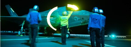 Sailors assigned to the forward-deployed amphibious assault ship USS America (LHA 6) complete flight operations with an F-35B Lightning II fighter aircraft from Marine Fighter Attack Squadron (VMFA) 121 while conducting routine operations in the Philippine Sea, July 13.