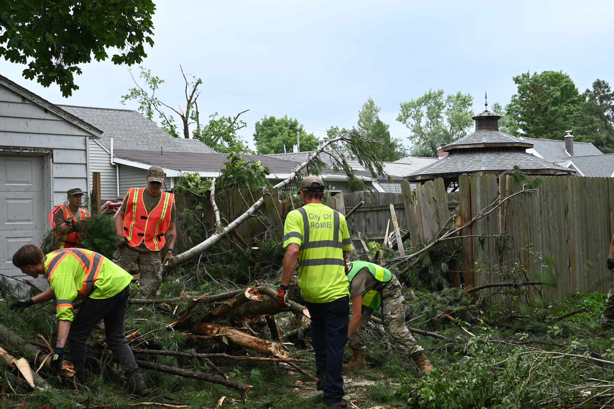 New York Air National Guard Airmen assigned to the 174th Attack Wing clear debris in Rome, New York, July 17, 2024, alongside city employees. The New York National Guard deployed 25 Airmen from the 174th Attack Wing, 25 Soldiers from the 2nd Battalion, 108th Infantry, and an additional 10 Soldiers to help clear debris left by a July 16 storm.