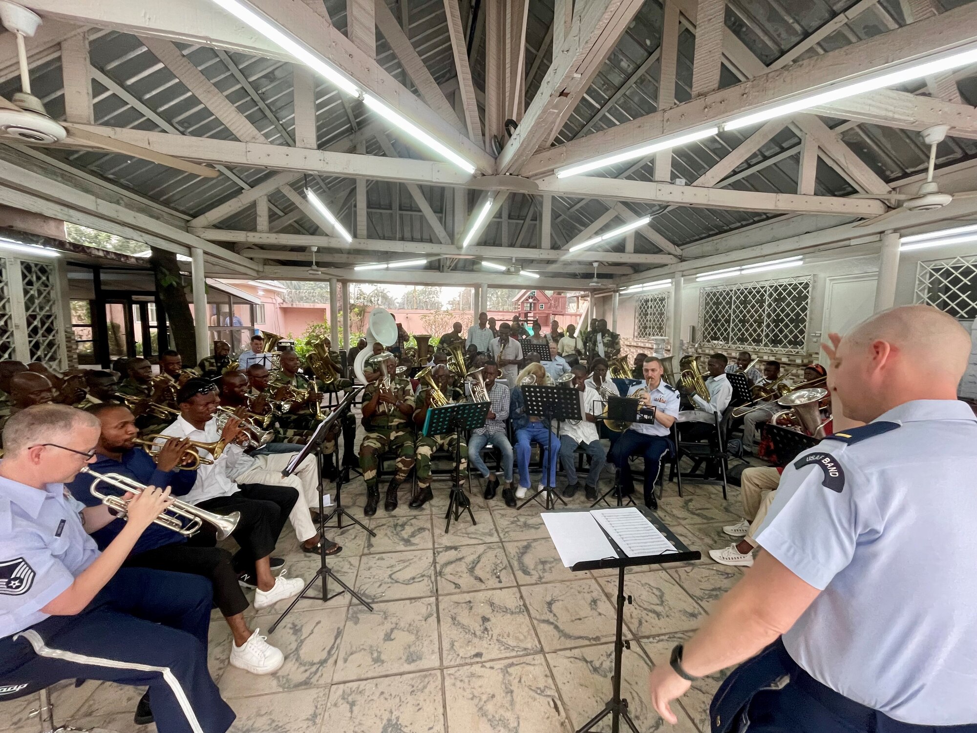 U.S. Air Forces in Europe-Air Forces Africa Band brass quintet “Five Star Brass” rehearses with Congolese Army Band Brazzaville and students of the School of Art for a joint concert at the Memorial Pierre Savorgnan de Brazza. 2Lt Jay Sconyers is conducting the joint orchestra performing the Congolese piece “Hymne de la Paix”. The USAFE-AFAFRICA Band serves as a bridge to increase cultural ties and enrich the partnerships between the U.S. and Republic of the Congo through music. (U.S. Air Force photo by Dominik Halnais)