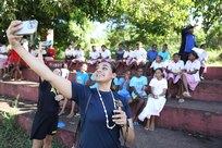 PORT VILA, Vanuatu (July 18, 2024) – Hospital Corpsman 2nd Class Misha Patel, of Tampa, Fla. takes a selfie with students at the Kawenu Primary School, during a community outreach event as part of Pacific Partnership 24-2 in Port Vila, Vanuatu, July 18, 2024. Pacific Partnership the U. S. Navy's largest humanitarian and civic assistance mission with partner-nations, non-governmental organizations and other government agencies to execute a variety of humanitarian civic action missions across the Indo-Pacific. The annual mission is designed to strengthen relationships and improve U.S. and partner-capacity to deliver humanitarian assistance and disaster-relief preparedness. (U.S. Navy photo by Mass Communication Specialist 1st Class Ryan D. McLearnon/Released)