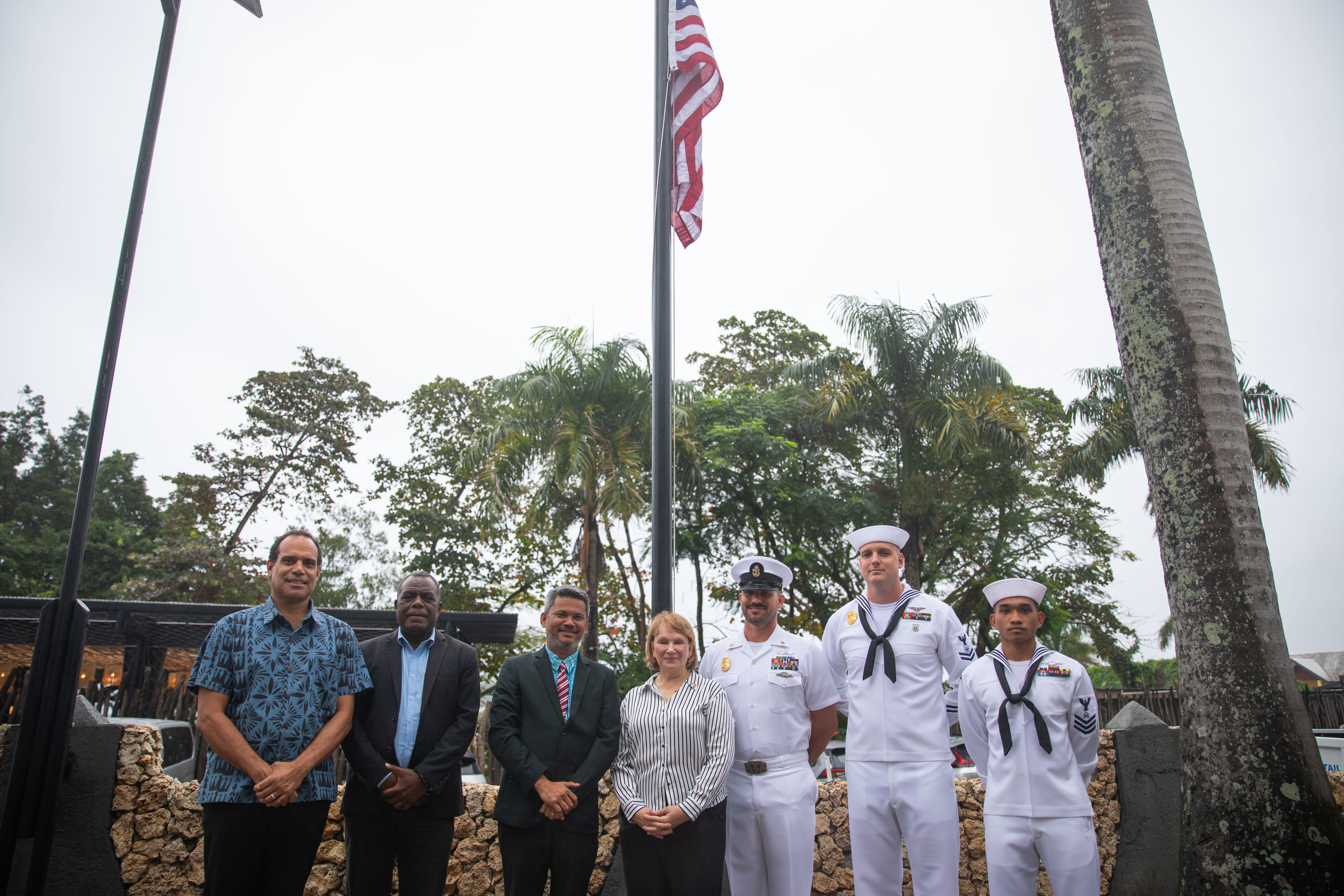 PORT Vila, Vanuatu (July 19, 2024) – left to right, The Hon Ralph Regenvanu, Vanuatu’s Minister of Climate Change Adaptation, Pastor Colin Keleb, Chairman of the Vanuatu Christian Council (VCC), the Hon Matai SEREMAIAH Nawalu, Vanuatu’s Deputy Prime Minister and Minister of Foreign Affairs, Ambassador Ann Marie Yastishock, U.S. Ambassador to the Independent State of Papua New Guinea, Solomon Islands and the Republic of Vanuatu, Chief Master-at-Arms Jon Cox, of Tyler, Texas, Logistics Specialist Submarine 1st Class Hsien Clod Pascua, of Honolulu and Master-at-Arms 2nd Class Joseph Dezamits of Scott Township, Pa., stand in front of the American flag at the opening ceremony of the U.S. Embassy in Port Vila, Vanuatu, July 19, 2024. The United States established diplomatic relations with the Government of Vanuatu in 1986. Ambassador Ann Marie Yastishock, is accredited to Vanuatu as the nonresident Ambassador and leads the diplomatic mission based in Port Vila. This opening further marks the growth of our relationship with Vanuatu and underlines the strength of our commitment to our bilateral relations, to the Ni-Vanuatu people, and to our partnerships in the Indo-Pacific region. (U.S. Navy photo by Lt. j.g. Winslow Blow/Released)