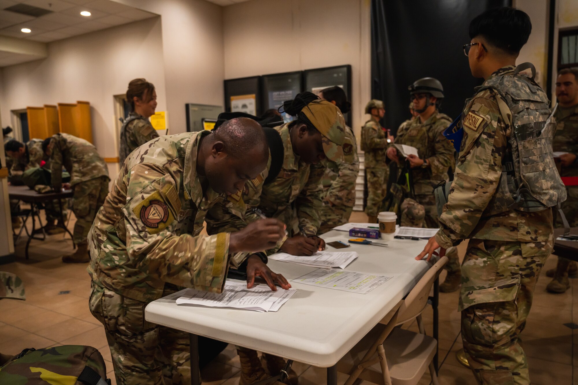 U.S. Air Force Staff Sgt. Emmanuel Agyemang Duah, 8th Comptroller Squadron financial analysis supervisor, fills out paperwork at the base theater during exercise Beverly Sentinel 24-2 at Kunsan Air Base.